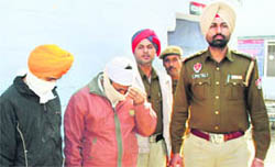 SGPC employees who were arrested for possessing fake currency, in Amritsar on Sunday.