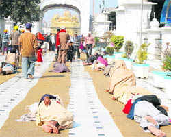 The mats, laid out in the Golden Temple complex for the convenience of the pilgrims as the mercury dips, are being used by some for an afternoon siesta on Sunday.