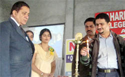 Dignitaries lighting a lamp during the national seminar at MD College in Abohar.