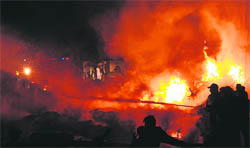 FIGHTING THE FLAMES: Pakistani firemen extinguish the fire caused by a Russian-made cargo plane that crashed after taking off from the Karachi airport on Sunday.