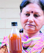 Kusum Parti, a resident of Sector 18, displays a sample of muddy tap water on Monday.