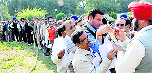 Employees of UT administration queue up outside the CHB office on Monday. 