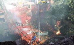 Firemen try to douse the flames at the four-storeyed building at Chandni Chowk in Old Delhi 