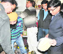 City Magistrate R Sreedhar Babu and health officials take food samples at a food outlet in the Ranipur area of Haridwar on Monday. 