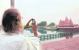 A sadhu captures Brahamasarover on his mobile phone in Kurukshetra.