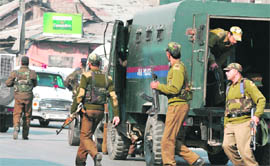 Securitymen rush to the scene of the encounter at Qamarwari in Srinagar on Monday.