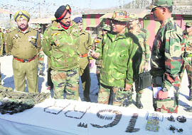 Lt-Gen Rameshwar Roy, GOC,16 Corps, (centre) looks at arms and ammunition recovered from slain militants in Surankote on Monday.