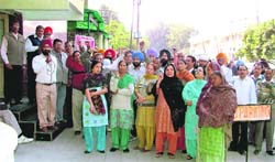 BSNL employees hold a protest in support of their demands in Ludhiana on Monday.