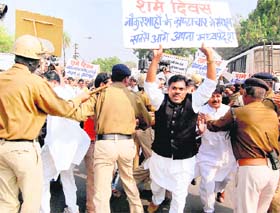 Cops try to control Congress MLAs during a protest against BJP Karyakarta Gaurav Divas celebrations in Bhopal on Monday