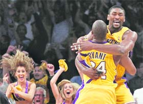 Los Angeles Lakers forward Ron Artest jumps into the arms of team-mate Kobe Bryant after scoring the game-winning basket against the Phoenix Suns in the NBA Western Conference final playoffs in Los Angeles.