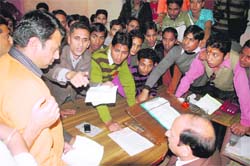 Students protest before the Principal of DAV (PG) College in Dehradun on Tuesday