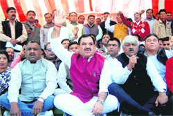 Congress leaders hold a protest at the Gandhi Park in Dehradun