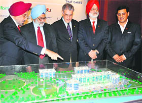 Impact Senior Living Estates chairman Harpal Singh shows the project model to Justice SS Sodhi (2nd from L), a former Chief Justice of Allahabad High Court, in Chandigarh on Tuesday.