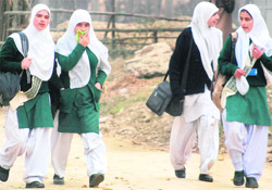 Girls go to school at Kakapora on the outskirts of Srinagar on Tuesday as there was no bandh call given by the Hurriyat Conference