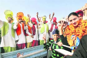 Manjeet Kaur, a member of the gold medal winning 4x100 womens relay team at the Asian Games, is welcomed on her arrival at Jalandhar railway station