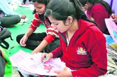 Students participate in a painting competition at an AIDS awareness campaign in Dehradun on Wednesday.