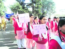 Students take out a rally on World AIDS Day in Mussoorie on Wednesday. 
