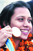 Mandeep Kaur shows her medal after reaching Amritsar
