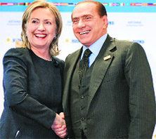 Italy's Prime Minister Silvio Berlusconi (R) shakes hands with US Secretary of State Hillary Clinton during the Organisation for Security and Cooperation in Europe Summit in Astana on Wednesday.  Reuters