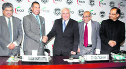 IMF Managing Director Dominique Strauss-Kahn (C) shakes hands with Ficci President Rajan Bharti Mittal as Unique Identification Development Authority of India (UIDAI) Chairman Nandan Nilekani (L), Chief Economic Advisor Kaushik Basu (R) and former RBI Governor YV Reddy look on at Ficci headquarters in New Delhi