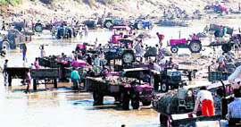 Workers carry out quarrying on the Ganga river bed in Haridwar.