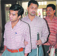 Two visually impaired students inside a polling booth during the Lok Sabha elections of 2009 in Dehradun.