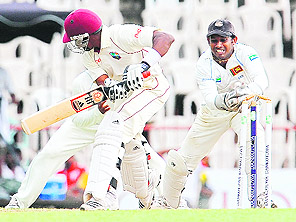 Sri Lankan wicketkeeper Prasanna Jayawardene stumps West Indies batsman Dwayne Bravo during the second day of the third and final Test match in Pallekele on Thursday. 