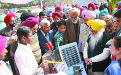 Punjab Education Minister takes a look at models at the State Science Exhibition in Amritsar 
