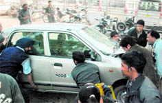 The mangled remains of a demo Maruti Suzuki SX4 car after it hit cars parked outside an automobile showroom in Industrial Area, Phase I; people lift a damaged Alto car to pull out 10-year-old schoolboy Suraj, who was trapped following the accident; and the injured boy being taken to the hospital in Chandigarh on Friday