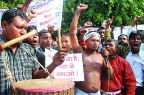 Members of the Tea Tribes Adivasi United Forum of Assam on Friday demonstrate for scheduled tribe status, near Parliament in New Delhi.