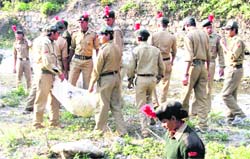 Cadets pick up the filth at Guchu Paani on Friday.