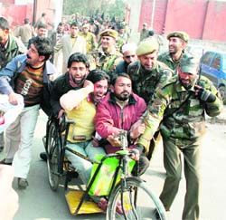 Members of the All-Jammu and Kashmir Handicapped Association going to the UN office to submit a charter of demands being stopped by the police in Srinagar on Friday