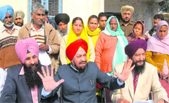 BS Ramoowalia presents members of the families of youths stranded abroad before mediapersons in Jalandhar 