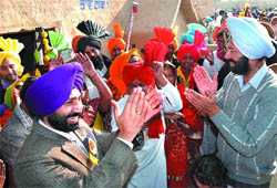 Deputy Commissioner Gurkirat Kirpal Singh (right) and SSP Sukhchain Singh Gill sway to the tune of a folk song during the ongoing Virasat Mela at Jaipalgarh village in Bathinda on Saturday