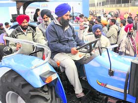 A farmer tries his hands on a tractor at Agro Tech 2010 in Chandigarh on Saturday. 