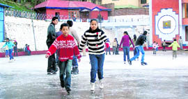 Children enjoy ice-skating at the rink in Shimla on Saturday.