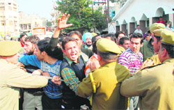 Members of the All-Jammu and Kashmir Physiotherapists Association scuffle with the police during a protest at Parade in Jammu 