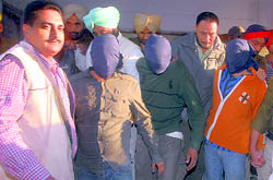 Three persons (with faces covered) arrested during an encounter at Kharar are produced in court on Saturday