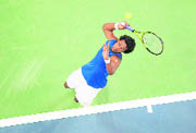 France's Gael Monfils (in pic) serves to Serbia's Janko Tipsarevic during their Davis Cup final tennis match in Belgrade on Saturday.