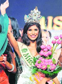 The earths the limit: Newly crowned Miss Earth 2010 Nicole Faria of India waves at the final of the contest held in central city of Nha Trang