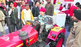 A child tries his hands on a mini tractor at Agro Tech 2010 in Chandigarh on Sunday.