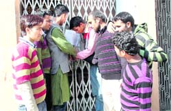 Students lock the law department of DAV College in Dehradun on Friday. 