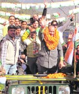 PCC chief Kaul Singh waves at supporters in Dharamsala on Sunday. 