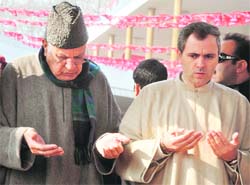 Union Minister for New and Renewable Energy Farooq Abdullah and Chief Minister Omar Abdullah offer prayers at the grave of the founder of the National Conference, Sheikh Abdullah in Srinagar on Sunday. 