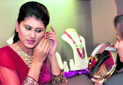 A model displays a jewellery design at a wedding exhibition in Ludhiana
