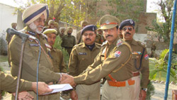 Anantjit Singh Sandhu, Divisional Commandant, PHG, honours an officer on Foundation Day. 