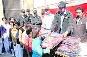School bags and educational material being given to poor students of Uttaranchal Public School at Roshanabad in Haridwar