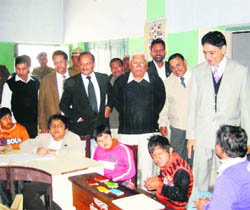 District and sessions judge RS Baswana and CJM Rajesh Garg with physically and mentally disabled children at Chetna centre in Kaithal.