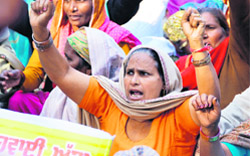 Activists of Sangharsh Committee of the Scheduled Tribes protest in Ludhiana