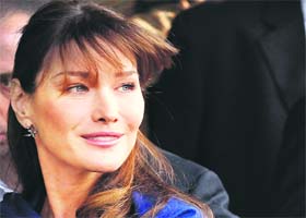French First Lady Carla Bruni-Sarkozy smiles she leaves a hospital in New Delhi